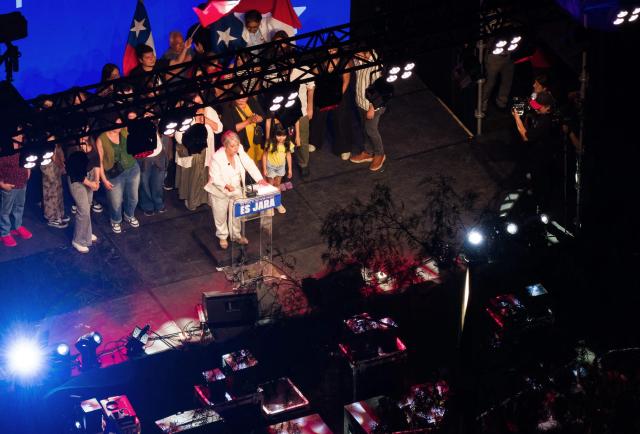 This aerial view shows Chile's presidential candidate Jeannette Jara, of the Unidad por Chile coalition, delivering a speech after the first exit poll results of the general election in Santiago on November 16, 2025. (Photo by Javier TORRES / AFP)