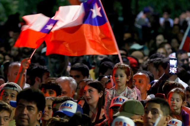 Supporters of Chile's presidential candidate Jose Antonio Kast, of the Partido Republicano party, attend his speech after the first exit poll results of the general election in Santiago on November 16, 2025. Leftist former labor minister Jeannette Jara and far-right leader Jose Antonio Kast were leading the country's presidential race on November 16, 2025, according to partial results, which show them heading to a December run-off. (Photo by Raul BRAVO / AFP)