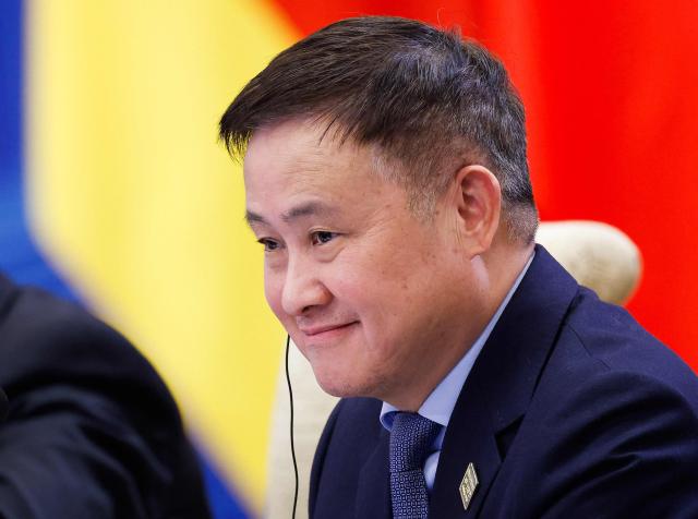 Pan Gongsheng, Governor of the People's Bank of China, reacts during a high-level meeting with German Vice Chancellor and Finance Minister Lars Klingbeil at the Diaoyutai State Guesthouse in Beijing on November 17, 2025. (Photo by Maxim Shemetov / POOL / AFP)
