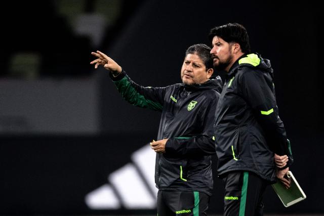Bolivia's head coach Oscar Villegas (L) gestures during a training session ahead of their friendly football match against Japan at the National Stadium in Tokyo on November 17, 2025. (Photo by Philip FONG / AFP)