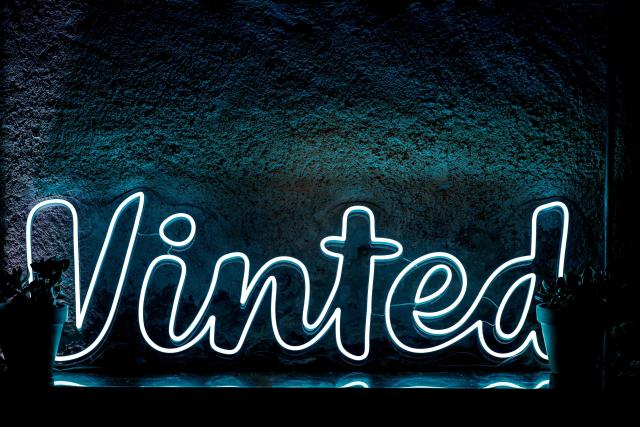 (FILES) This photograph shows Vinted logo displayed during a presser of the company in Paris on October 3, 2024. Vinted faces an investigation in France over allegations that some accounts on the second-hand clothes platform are being used to promote pornographic content, the government's child protection commissioner said. French news website L'Informé and other media reported last week how some users are posting advertisements for lingerie or swimwear to attract users to their profiles on adult-content sites such as OnlyFans. (Photo by STEPHANE DE SAKUTIN / AFP)