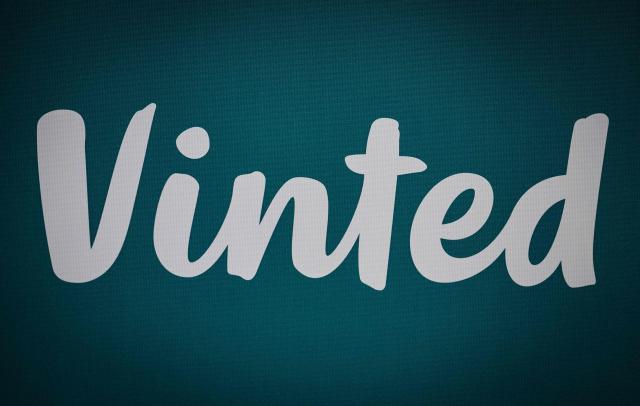 (FILES) This photograph shows Vinted logo displayed during a presser of the company in Paris on October 3, 2024. Vinted faces an investigation in France over allegations that some accounts on the second-hand clothes platform are being used to promote pornographic content, the government's child protection commissioner said. French news website L'Informé and other media reported last week how some users are posting advertisements for lingerie or swimwear to attract users to their profiles on adult-content sites such as OnlyFans. (Photo by STEPHANE DE SAKUTIN / AFP)