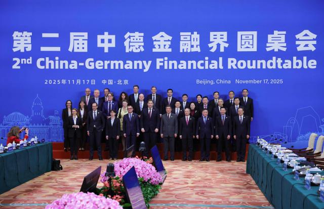 Delegation members from China and Germany pose for the official photo during a high-level meeting at the Diaoyutai State Guesthouse in Beijing on November 17, 2025. (Photo by Maxim Shemetov / POOL / AFP)
