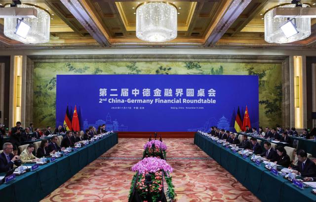 Delegation members from China and Germany pose attend a high-level meeting at the Diaoyutai State Guesthouse in Beijing on November 17, 2025. (Photo by Maxim Shemetov / POOL / AFP)