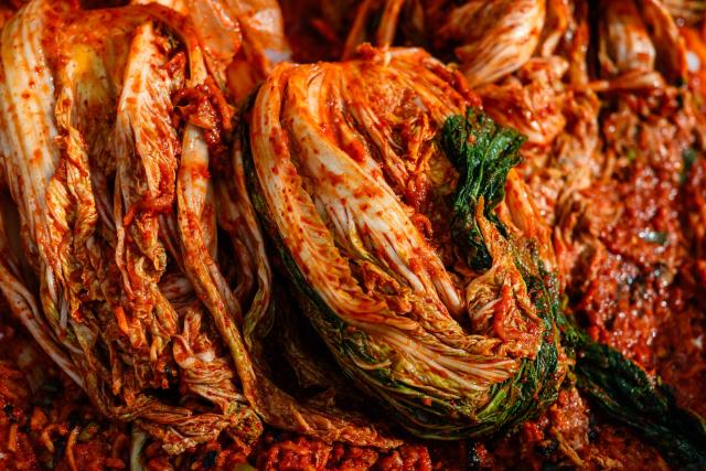 Freshly prepared kimchi is seen during a kimchi making festival at Garak Market in Seoul on November 17, 2025. (Photo by ANTHONY WALLACE / AFP)