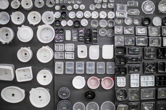 Single use food plastic containers are seen on display outside a wholesale dealer’s store in Seoul on November 17, 2025. (Photo by ANTHONY WALLACE / AFP)