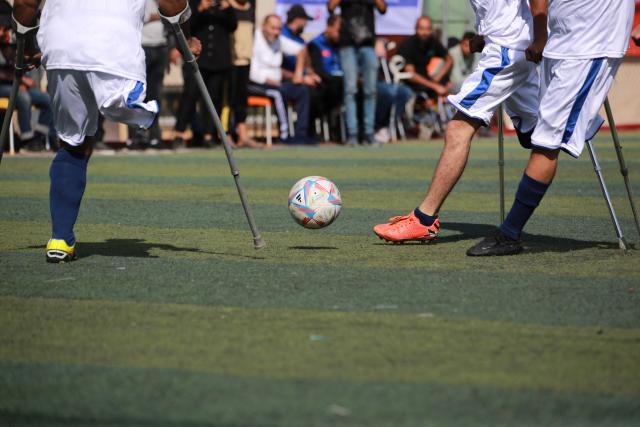 Palestinian amputees take part in a football match as part of the Hope Tournament organised by the Deniz Feneri Association and the Palestine Amputee Football Association in Deir al-Balah in the central Gaza Strip on November 17, 2025. The UN Security Council will vote on a resolution endorsing US President Donald Trump's Gaza peace plan, diplomats said. A draft of the resolution seen last week by AFP "welcomes the establishment of the Board of Peace," a transitional governing body for Gaza -- that Trump would theoretically chair -- with a mandate running until the end of 2027. Unlike previous drafts, the latest mentions a possible future Palestinian state. (Photo by Bashar Taleb / AFP)