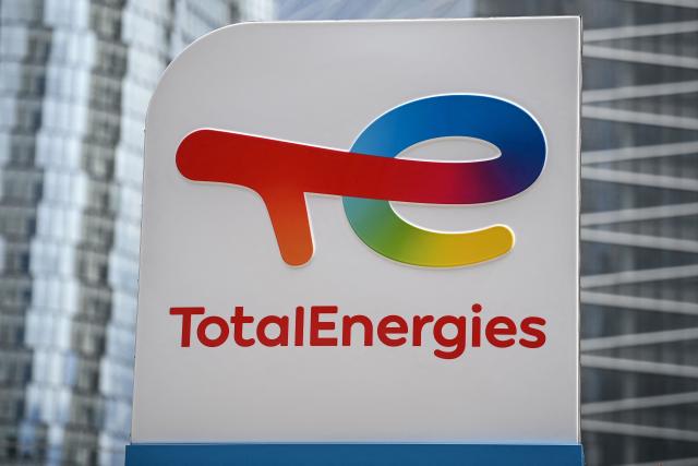 (FILES) This photograph taken on May 28, 2021 shows the new TotalEnergies logo during its unveling ceremony, at La Defense on the outskirts of Paris. TotalEnergies and Kretinsky are set to join forces in electricity production in Western Europe through a joint venture and a share exchange operation, whereby the Czech billionaire will acquire a significant stake in the capital of the hydrocarbon giant. (Photo by Christophe ARCHAMBAULT / AFP)