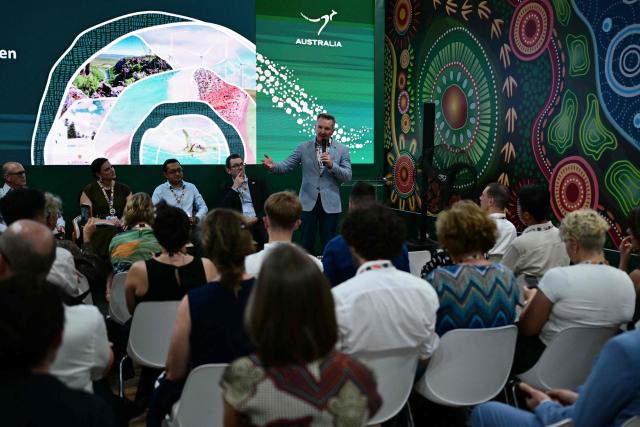 The Minister for Climate Change and Energy of Australia, Chris Bowen, speaks at Australia's pavilion during the COP30 UN Climate Change Conference in Belem, Para State, Brazil, on November 17, 2025. Bowen launched into public appearances on his first day at COP30 on Monday, making a light-hearted quip about the hosting war before a friendly crowd at the Australian pavilion. "I am in the middle of a lot of negotiations -- and not just about the most obvious things," Bowen said with a smile, drawing laughs from the crowd. Resolving the COP31 standoff is Bowen's top priority in Belem and the minister has bilateral meetings scheduled with his Turkish climate counterpart, Murat Kurum, a senior Australian government source told AFP. (Photo by Pablo PORCIUNCULA / AFP)