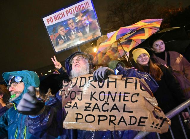 A demonstrator holds a placard reading "Comrade Fico, your end started in the city of Poprad", during a protest against the government of Slovakia's nationalist Kremlin-friendly Prime Minister Robert Fico on November 17, 2025 in Bratislava, Slovakia. Students of a highscool in Poprad had left the room during a speech of Fico on November 14, 2025 at their institution to signal dissent. Czechs and Slovaks rally in both countries, the anniversary of the 1989 Velvet Revolution that toppled communism in former Czechoslovakia, to denounce the leaders they say have betrayed its legacy. On November 17, 1989, communist police brutally crushed a peaceful student march in the centre of Prague, sparking an uprising that toppled the Moscow-steered regime after four decades. Like in the other Soviet-bloc countries at the time, the revolution restored democracy in Czechoslovakia, which then split into the Czech Republic and Slovakia four years later. (Photo by Joe Klamar / AFP)