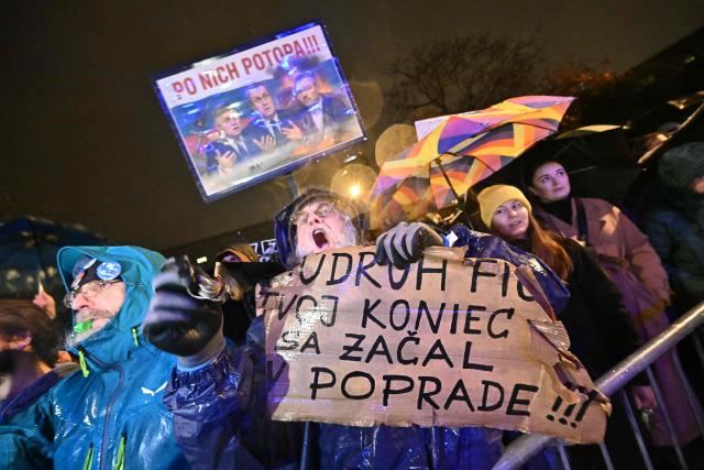 A demonstrator holds a placard reading "Comrade Fico, your end started in the city of Poprad", during a protest against the government of Slovakia's nationalist Kremlin-friendly Prime Minister Robert Fico on November 17, 2025 in Bratislava, Slovakia. Students of a highscool in Poprad had left the room during a speech of Fico on November 14, 2025 at their institution to signal dissent. Czechs and Slovaks rally in both countries, the anniversary of the 1989 Velvet Revolution that toppled communism in former Czechoslovakia, to denounce the leaders they say have betrayed its legacy. On November 17, 1989, communist police brutally crushed a peaceful student march in the centre of Prague, sparking an uprising that toppled the Moscow-steered regime after four decades. Like in the other Soviet-bloc countries at the time, the revolution restored democracy in Czechoslovakia, which then split into the Czech Republic and Slovakia four years later. (Photo by Joe Klamar / AFP)