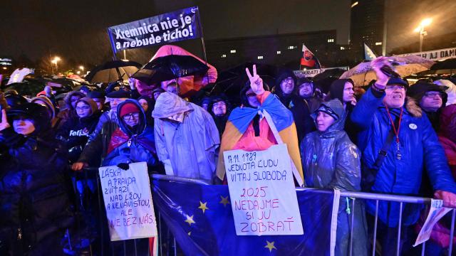 A demonstrator holds a placard reading "Kremnica is not and will not be quiet", during a protest against the government of Slovakia's nationalist Kremlin-friendly Prime Minister Robert Fico on November 17, 2025 in Bratislava, Slovakia. Students of a highscool in Poprad had left the room during a speech of Fico on November 14, 2025 at their institution to signal dissent. Czechs and Slovaks rally in both countries, the anniversary of the 1989 Velvet Revolution that toppled communism in former Czechoslovakia, to denounce the leaders they say have betrayed its legacy. On November 17, 1989, communist police brutally crushed a peaceful student march in the centre of Prague, sparking an uprising that toppled the Moscow-steered regime after four decades. Like in the other Soviet-bloc countries at the time, the revolution restored democracy in Czechoslovakia, which then split into the Czech Republic and Slovakia four years later. (Photo by Joe Klamar / AFP)