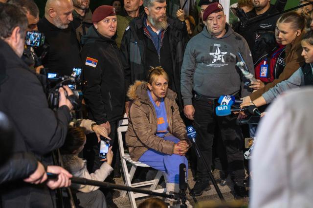 Dijana Hrka, a grieving Serbian mother who had been on a hunger strike for more than two weeks speaks to the press outside the Serbian National Assembly building, in Belgrade, as she ends her protest on November 17, 2025, vowing that she would not stop fighting for her son and for the country's anti-government movement. Dijana Hrka, whose son Stefan was among the 16 killed in a roof collapse last year which ignited the year-long movement, was so weak after nearly 16 days without food that she had to sit halfway through her announcement to media and supporters. Hrka has become a significant figure of the protests in Serbia, joining countless demonstrations and backing student demands for accountability and early elections. (Photo by Andrej ISAKOVIC / AFP)