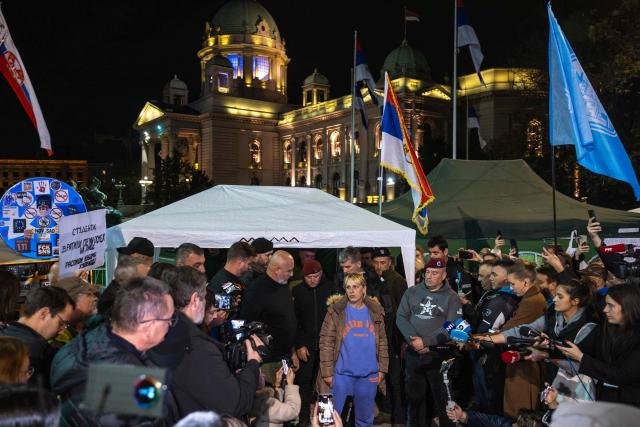 Dijana Hrka, a grieving Serbian mother who had been on a hunger strike for more than two weeks speaks to the press in front the Serbian National Assembly building, in Belgrade, as she ends her protest on November 17, 2025, vowing that she would not stop fighting for her son and for the country's anti-government movement. Dijana Hrka, whose son Stefan was among the 16 killed in a roof collapse last year which ignited the year-long movement, was so weak after nearly 16 days without food that she had to sit halfway through her announcement to media and supporters. Hrka has become a significant figure of the protests in Serbia, joining countless demonstrations and backing student demands for accountability and early elections. (Photo by Andrej ISAKOVIC / AFP)