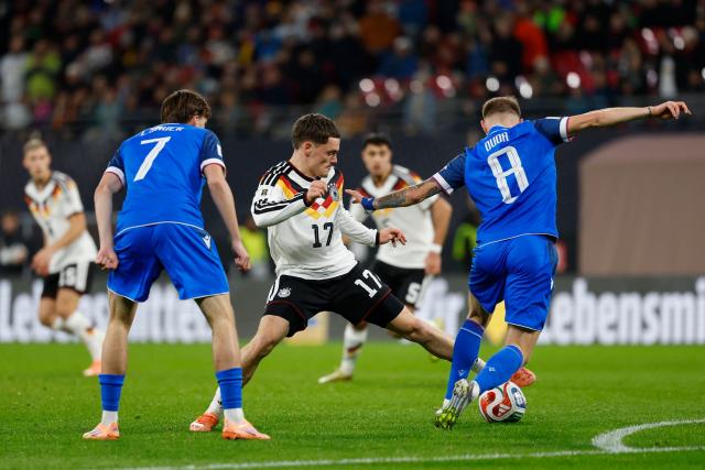 Germany's midfielder #17 Florian Wirtz vies for the ball with Slovakia's forward #07 Leo Sauer and Slovakia's midfielder #08 Ondrej Dudaduring the FIFA World Cup 2026 European qualification Group A football match between Germany and Slovakia in Leipzig, eastern Germany on November 17, 2025. (Photo by Odd ANDERSEN / AFP)