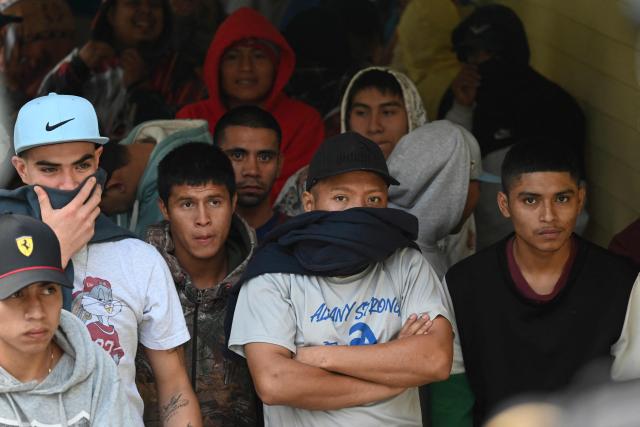 Mara Salvatrucha gang members wait during a riad at Pavoncito prision in Fraijanes, Guatemala on November 17, 2025. The operation is part of measures announced by the new security authorities to regain control of the country's prisons following the October escape of 20 Barrio 18 gang leaders from Fraijanes II Prison, adjacent to Pavoncito. (Photo by Johan ORDONEZ / AFP)