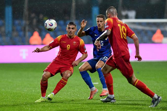 Croatia's midfielder #15 Mario Pasalic (C) fights for the ball with Montenegro's forward #09 Nikola Krstovic during the FIFA World Cup 2026 European qualification Group L football football match between between Montenegro and Croatia at Gradski Stadium in Podgorica on November 17, 2025. (Photo by SAVO PRELEVIC / AFP)