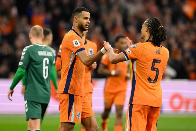 Netherlands' forward #11 Cody Gakpo (L) celebrates with Netherlands' defender #05 Nathan Ake (R) after scoring the Netherlands second goal from the penalty spot during the FIFA World Cup 2026 Group G European qualification football match between the Netherlands and Lithuania at the Johan Cruijff Arena, in Amsterdam, on November 17, 2025. (Photo by JOHN THYS / AFP)