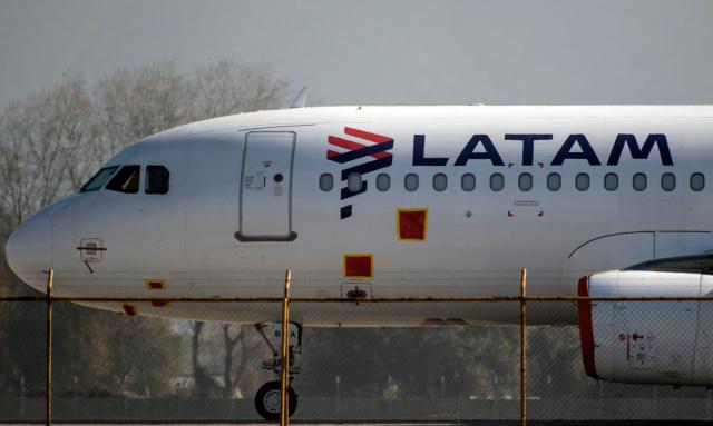 (FILES) A LATAM airlines plane sits on the tarmac at Santiago International Airport in Santiago on May 26, 2020. LATAM, South America's largest airline, announced on November 17, 2025, that it will suspend scheduled flights until November 22, affecting 10,000 passengers due to a strike by one of the pilots' unions in Chile seeking better wages. (Photo by MARTIN BERNETTI / AFP)