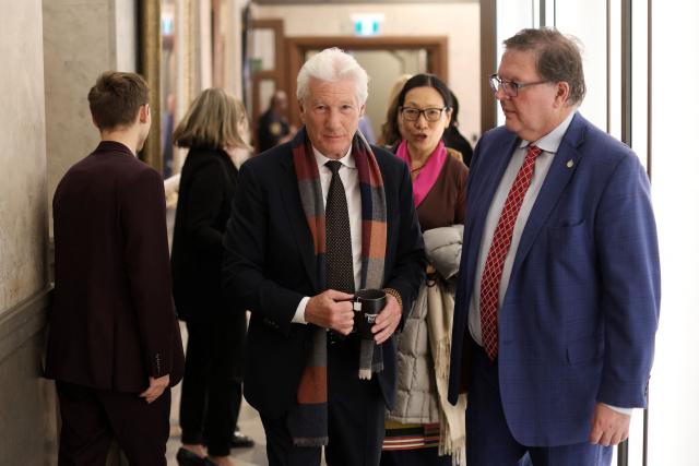 US actor Richard Gere (C) walks to The House of Commons after meeting with Members of Parliament on November 17, 2025 in Ottawa, Canada the day of the final vote on State budget. Canada's Liberal government survived a confidence vote on November 17, as parliament narrowly passed a budget Prime Minister Mark Carney says is essential to bolster an economy threatened by US tariffs. 
The minority Liberal government faced collapse over the cliffhanger budget vote, but a small group of opposition lawmakers -- weary of triggering a snap election -- allowed the fiscal plan to pass. (Photo by Dave Chan / AFP)