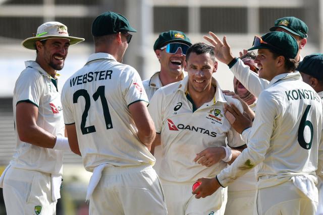 (FILES) Australia's Scott Boland (C) celebrates the dismissal of West Indies' Jomel Warrican during the third day of the third Test cricket match between West Indies and Australia at Sabina Park in Kingston, Jamaica, on July 14, 2025. Australia might be without star quicks Pat Cummins and Josh Hazlewood for the opening Ashes Test against England on November 21, 2025, but they have the luxury of calling on perhaps the best "spare" fast bowler in the world. (Photo by Randy Brooks / AFP) / To go with AFP story Cricket-AUS-ENG-Ashes-Boland, PROFILE by Martin Parry