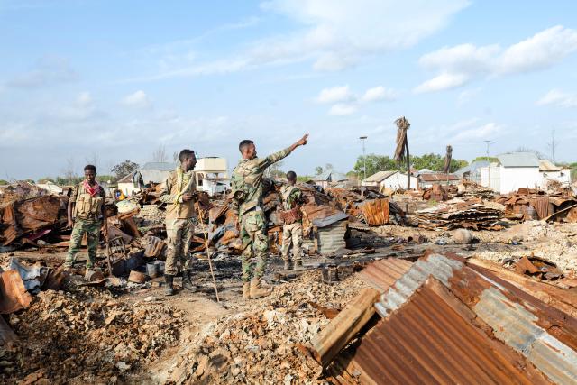 Soldiers of the Somalia National Army (SNA) secure a village that ws allegedly destroyed by retreating insurgents during a visit by senior officers at Awdheegle, one of several towns recently liberated from the Al-Qaeda-linked militants, Al-Shabaab, by the SNA in Somalia's lower-Shabelle region on November 11, 2025. Somalia has been fighting Al-Shabaab since mid-2000s, and settlements like Awdheegle, Sabiid and Canole have changed hands multiple times.
In 2022 and 2023, the national army made significant progress, capturing some 200 towns and villages from Al-Shabaab.
But Al-Shabaab launched a new offensive early this year, retaking some 90 percent of that territory -- including three critical bridges along the Shabelle River vital for access to the capital.
The army is pushing back, but must do so just as international assistance is faltering. (Photo by Tony KARUMBA / AFP)