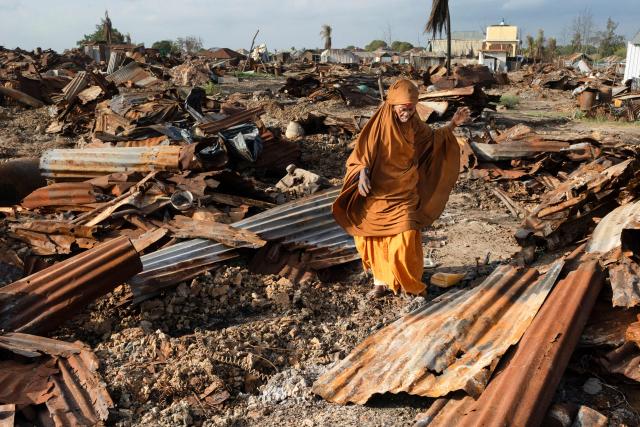 A woman salvages burnt iron sheets where her home was destroyed allegedly by retreating insurgents at Awdheegle, one of several towns recently liberated from the Al-Qaeda-linked militants, Al-Shabaab, by the SNA in Somalia's lower-Shabelle region on November 11, 2025. Somalia has been fighting Al-Shabaab since mid-2000s, and settlements like Awdheegle, Sabiid and Canole have changed hands multiple times.
In 2022 and 2023, the national army made significant progress, capturing some 200 towns and villages from Al-Shabaab.
But Al-Shabaab launched a new offensive early this year, retaking some 90 percent of that territory -- including three critical bridges along the Shabelle River vital for access to the capital.
The army is pushing back, but must do so just as international assistance is faltering. (Photo by Tony KARUMBA / AFP)