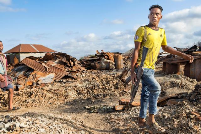 An armed villager walks through the rubble of their village that was allegedly destroyed by retreating insurgents at Awdheegle, one of several towns recently liberated from the Al-Qaeda-linked militants, Al-Shabaab, by the SNA in Somalia's lower-Shabelle region on November 11, 2025. Somalia has been fighting Al-Shabaab since mid-2000s, and settlements like Awdheegle, Sabiid and Canole have changed hands multiple times.
In 2022 and 2023, the national army made significant progress, capturing some 200 towns and villages from Al-Shabaab.
But Al-Shabaab launched a new offensive early this year, retaking some 90 percent of that territory -- including three critical bridges along the Shabelle River vital for access to the capital.
The army is pushing back, but must do so just as international assistance is faltering. (Photo by Tony KARUMBA / AFP)