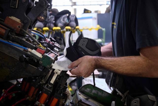 An employee works at the AMF safety shoes  factory in Tabuadelo, near Guimaraes, on November 17, 2025. (Photo by MIGUEL RIOPA / AFP)
