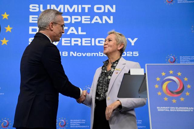 France's Minister Delegate for Artificial Intelligence Anne Le Henanff (R) and German Minister for Digitalization and State Modernization Karsten Wildberger shake hands after addressing a press conference during a summit on Europe's technological sovereignty, on November 18, 2025 at the EUREF Campus in Berlin. The German Chancellor and the French President will join forces to push for greater European digital "sovereignty" and less dependence on US tech titans as the AI race gathers pace. The leaders of Europe's biggest economies will make the call at a Berlin summit, which will also be attended by CEOs of top regional firms including French AI company Mistral and German software giant SAP. With artificial intelligence set to play an increasingly important role in many sectors, Europe's leaders are responding to growing calls for the continent to take greater control of its own digital destiny. (Photo by John MACDOUGALL / AFP)