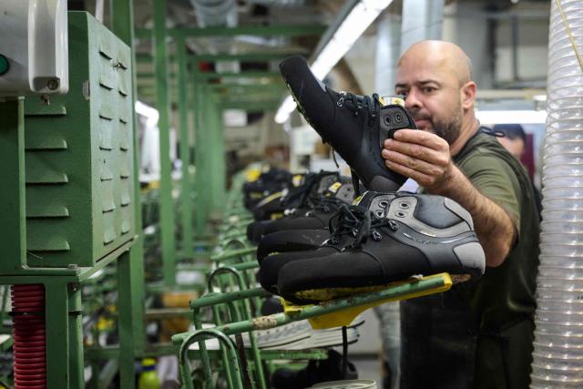 An employee works at the AMF safety shoes  factory in Tabuadelo, near Guimaraes, on November 17, 2025. (Photo by MIGUEL RIOPA / AFP)