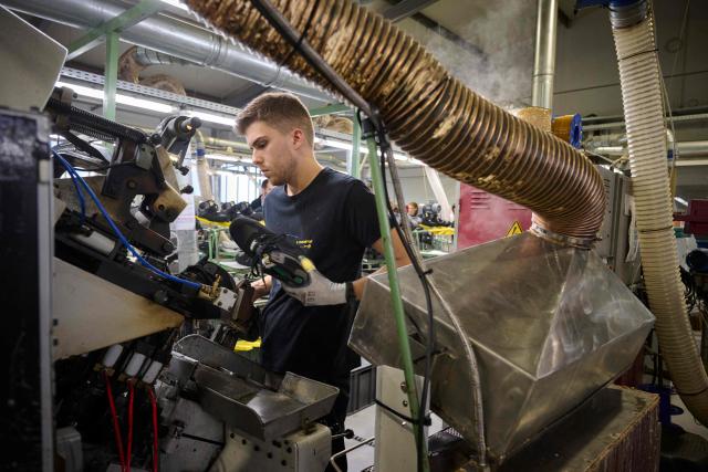 An employee works at the AMF safety shoes  factory in Tabuadelo, near Guimaraes, on November 17, 2025. (Photo by MIGUEL RIOPA / AFP)