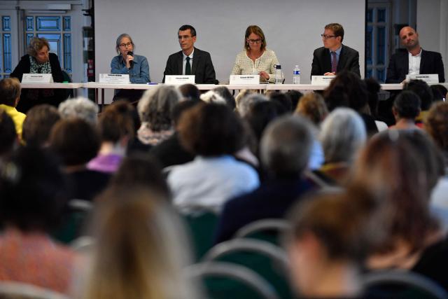 (FILES) Co-presidents of the commission Edouard Durand and Nathalie Mathieu listen to a victim of sexual abuse during a public meeting by the "Commission Independante sur l'Inceste et les Violences Sexuelles faites aux Enfants" (CIIVISE) at the Palais de la Femme in Paris, on September 21, 2022. The Commission on Sexual Violence Against Children ("Commission Independante sur l'Inceste et les Violences Sexuelles faites aux Enfants" CIIVISE) has raised awareness about this ‘mass crime,’ but two years after its recommendations, it is struggling to make concrete progress in the fight against child sexual abuse due to a lack of resources and political support. (Photo by JULIEN DE ROSA / AFP)