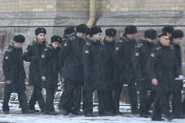 Young military cadets walk during a snowfall in Saint Petersburg on November 18, 2025. (Photo by Olga MALTSEVA / AFP)