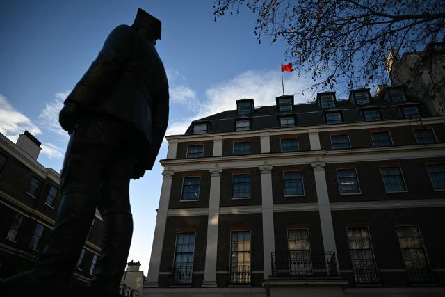 A flag flies atop a pole on the roof of the Embassy of the People's Republic of China in the United Kingdom, on Portland Place in London on November 18, 2025. Britain's domestic intelligence agency MI5 on November 18, warned that China was trying to recruit parliamentarians through spies disguised as headhunters, amid concern over Beijing's activities in the UK. There have been heightened fears about Chinese espionage in the UK after a politically sensitive case against two alleged spies was dropped, and as the government mulls a request from Beijing to build a controversial new embassy building in London. (Photo by JUSTIN TALLIS / AFP)