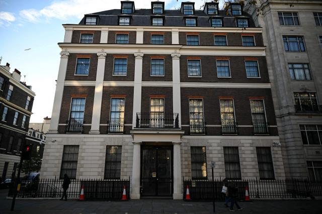 People walk past the Embassy of the People's Republic of China in the United Kingdom, on Portland Place in London on November 18, 2025. Britain's domestic intelligence agency MI5 on November 18, warned that China was trying to recruit parliamentarians through spies disguised as headhunters, amid concern over Beijing's activities in the UK. There have been heightened fears about Chinese espionage in the UK after a politically sensitive case against two alleged spies was dropped, and as the government mulls a request from Beijing to build a controversial new embassy building in London. (Photo by JUSTIN TALLIS / AFP)