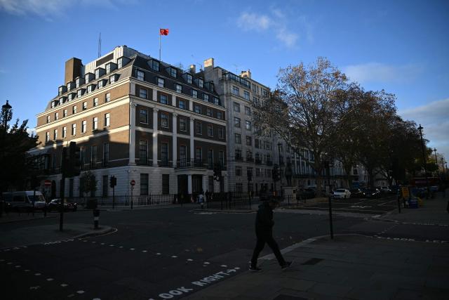 A flag flies atop a pole on the roof of the Embassy of the People's Republic of China in the United Kingdom, on Portland Place in London on November 18, 2025. Britain's domestic intelligence agency MI5 on November 18, warned that China was trying to recruit parliamentarians through spies disguised as headhunters, amid concern over Beijing's activities in the UK. There have been heightened fears about Chinese espionage in the UK after a politically sensitive case against two alleged spies was dropped, and as the government mulls a request from Beijing to build a controversial new embassy building in London. (Photo by JUSTIN TALLIS / AFP)