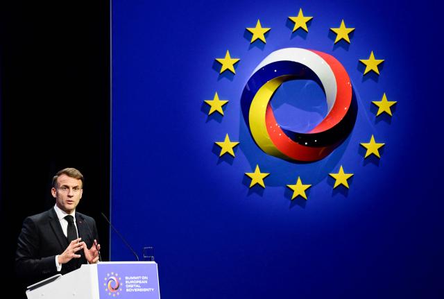 France's President Emmanuel Macron delivers a speech at the summit on Europe's technological sovereignty, on November 18, 2025 at the EUREF Campus in Berlin. The German Chancellor and the French President will join forces to push for greater European digital "sovereignty" and less dependence on US tech titans as the AI race gathers pace. The leaders of Europe's biggest economies will make the call at a Berlin summit, which will also be attended by CEOs of top regional firms including French AI company Mistral and German software giant SAP. With artificial intelligence set to play an increasingly important role in many sectors, Europe's leaders are responding to growing calls for the continent to take greater control of its own digital destiny. (Photo by John MACDOUGALL / AFP)