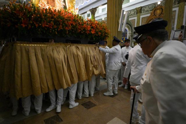 Members of the Servants of Mary religious society carry an image of Our Lady of the Rosary of Chiquinquira (Virgin of Chiquinquira) during a pilgrimage in Maracaibo, Zulia state, Venezuela, on November 18, 2025. (Photo by Juan BARRETO / AFP)
