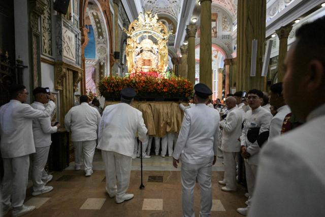 Members of the Servants of Mary religious society carry an image of Our Lady of the Rosary of Chiquinquira (Virgin of Chiquinquira) during a pilgrimage in Maracaibo, Zulia state, Venezuela, on November 18, 2025. (Photo by Juan BARRETO / AFP)