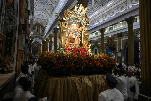 Members of the Servants of Mary religious society carry an image of Our Lady of the Rosary of Chiquinquira (Virgin of Chiquinquira) during a pilgrimage in Maracaibo, Zulia state, Venezuela, on November 18, 2025. (Photo by Juan BARRETO / AFP)
