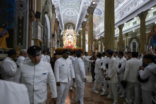 Members of the Servants of Mary religious society take part in a pilgrimage of Our Lady of the Rosary of Chiquinquira (Virgin of Chiquinquira) in Maracaibo, Zulia state, Venezuela, on November 18, 2025. (Photo by Juan BARRETO / AFP)