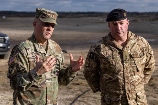 Brigadier General Curtis W. King (L) - the Commanding General for US 10th Army Air and Missile Defense Command, and British Brigadier Chris Gent (R) - Deputy Chief of Staff Transformation and Integration within NATO Headquarters Allied Land Command, speak to the press before the American MEROPS counter drone system tests at the Nowa Deba military training ground, south-eastern Poland, on November 18, 2025. (Photo by Wojtek RADWANSKI / AFP)