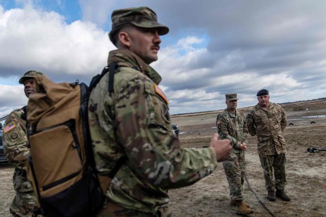 Brigadier General Curtis W. King (2nd R) - the Commanding General for US 10th Army Air and Missile Defense Command, and British Brigadier Chris Gent (R) - Deputy Chief of Staff Transformation and Integration within NATO Headquarters Allied Land Command, speak to the press before the American MEROPS counter drone system tests at the Nowa Deba military training ground, south-eastern Poland, on November 18, 2025. (Photo by Wojtek RADWANSKI / AFP)