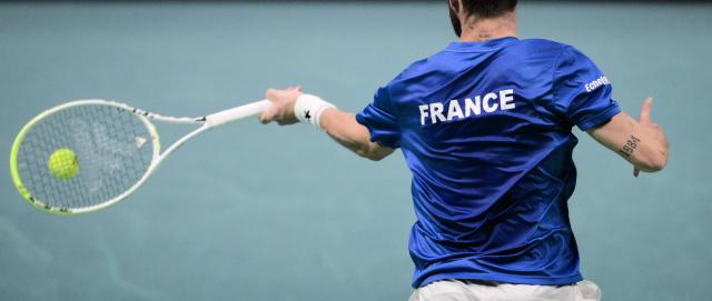 France's Corentin Moutet plays a forehand return to Belgium's Raphael Collignon during their Davis Cup men's singles quarter finals tennis match, at the Super Tennis Arena, in Bologna, northen Italy, on November 18, 2025. (Photo by Tiziana FABI / AFP)