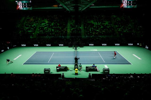 Belgium's Raphael Collignon (R) hits a return to France's Corentin Moutet during their Davis Cup men's singles quarter finals tennis match, at the Super Tennis Arena, in Bologna, northen Italy, on November 18, 2025. (Photo by Tiziana FABI / AFP)