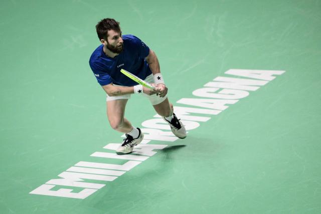 France's Corentin Moutet runs to hit a return to Belgium's Raphael Collignon during their Davis Cup men's singles quarter finals tennis match, at the Super Tennis Arena, in Bologna, northen Italy, on November 18, 2025. (Photo by Tiziana FABI / AFP)