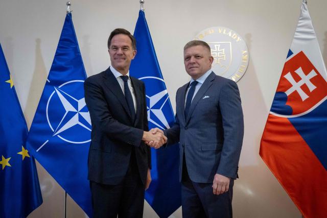 Prime Minister of Slovakia Robert Fico (R) shakes hands with NATO Secretary General Mark Rutte during his visit in Bratislava, Slovakia on November 18, 2025. (Photo by TOMAS BENEDIKOVIC / AFP)