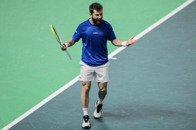 France's Corentin Moutet reacts as he plays against Belgium's Raphael Collignon during their Davis Cup men's singles quarter finals tennis match, at the Super Tennis Arena, in Bologna, northen Italy, on November 18, 2025. (Photo by Tiziana FABI / AFP)