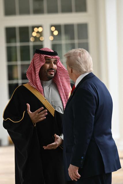 US President Donald Trump and Crown Prince and Prime Minister of the Kingdom of Saudi Arabia Mohammed bin Salman speaks as they walk down the Colonnade on the way to the Oval Office of the White House in Washington, DC on November 18, 2025. Saudi Crown Prince Mohammed bin Salman arrived at the White House to fanfare and a jet flyover Tuesday, in his first visit to the United States since the 2018 murder of journalist Jamal Khashoggi. (Photo by Brendan SMIALOWSKI / AFP)